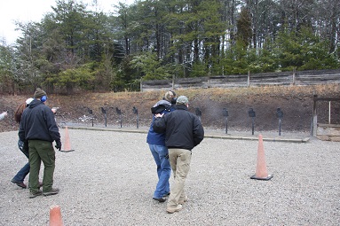 Instructors work with students on shooting while moving