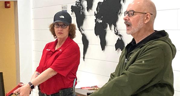 Presenting how to handle a small firearm during the Protecting Houses of Worship training workshop are Angela Armstrong (left) and Forrest Sonewald (right) of the Buckeye Firearms Association, which sponsored the event.
